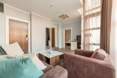 a living room with a couch and a table at Balkan Hotel Garni in Belgrade