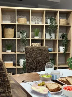 a table with a sandwich and a plate of food at Balkan Hotel Garni in Belgrade
