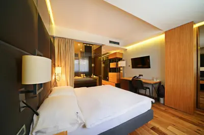 a bedroom with a large white bed and a desk at Apartments Belgrade in Belgrade