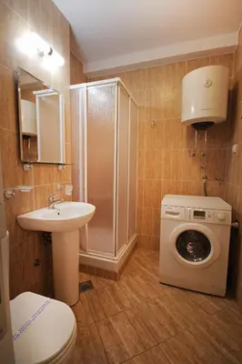 a bathroom with a washing machine and a washer at Apartments Belgrade in Belgrade