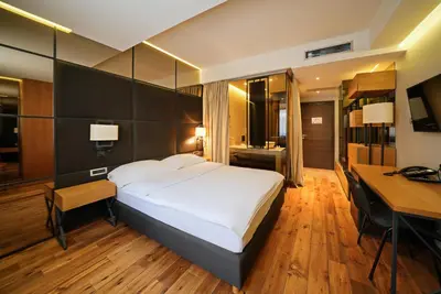 a hotel room with a large bed and a desk at Apartments Belgrade in Belgrade
