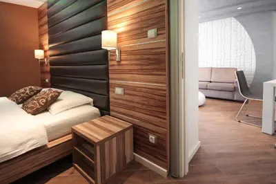 a bedroom with a bed with a wooden wall at Apartments Belgrade in Belgrade