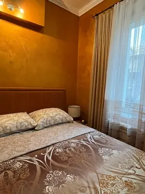 a bedroom with a bed and a window at Dalmatinska Apartman in Belgrade