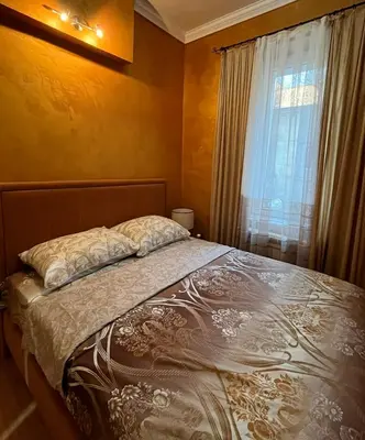 a bedroom with a large bed with a window at Dalmatinska Apartman in Belgrade