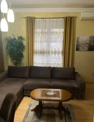 a living room with a couch and a table at Dalmatinska Apartman in Belgrade