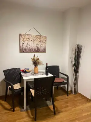 a dining room with a table with chairs and a painting at Belgrade with love in Novi Beograd
