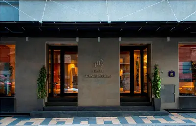 a hotel front of a building with two plants at Boutique Hotel Townhouse 27 in Belgrade
