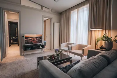 a living room with a couch and a television at Boutique Hotel Townhouse 27 in Belgrade