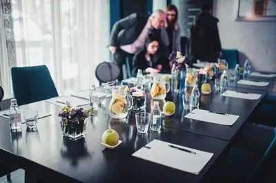 a group of people sitting around a long table at Boutique Hotel Townhouse 27 in Belgrade
