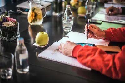 a person writing on a paper at a bar at Boutique Hotel Townhouse 27 in Belgrade