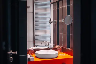 a bathroom with a sink and a mirror at Boutique Hotel Townhouse 27 in Belgrade