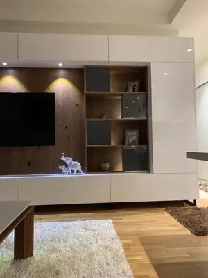 a living room with a large white entertainment center at Belgrade Waterfront Wolf in Sajmište