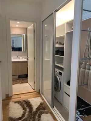 a laundry room with a washer and dryer next to a bathroom at Belgrade Waterfront Wolf in Sajmište
