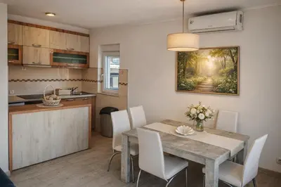 a kitchen and dining room with a table and chairs at President 034 Deluxe in Arandjelovac