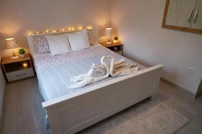 a bedroom with a bed with two pairs of shoes on it at President 034 Deluxe in Arandjelovac