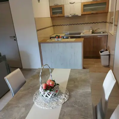 a kitchen with a table with a basket of apples on it at President 034 Deluxe in Arandjelovac