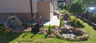 a garden of rocks and flowers in a yard at President 034 Deluxe in Arandjelovac