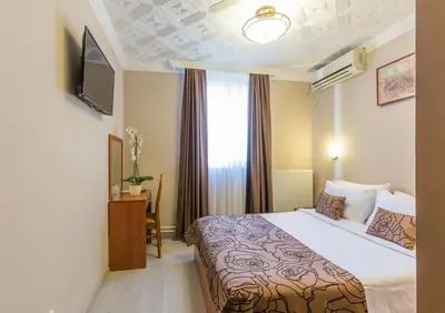 a hotel room with a bed and a window at Belgrade City Hotel in Belgrade