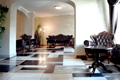 a lobby with chairs and a table in a room at Belgrade City Hotel in Belgrade