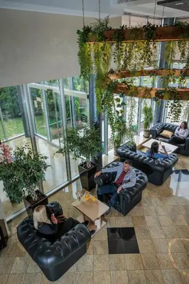 a group of people sitting on couches in a living room at Euro Garni Hotel in Belgrade