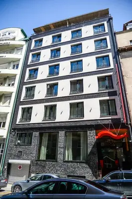 a tall building with cars parked in front of it at CRYSTAL Hotel Belgrade in Belgrade