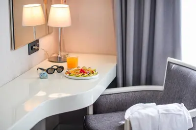 a hotel room with a table with a plate of food at CRYSTAL Hotel Belgrade in Belgrade