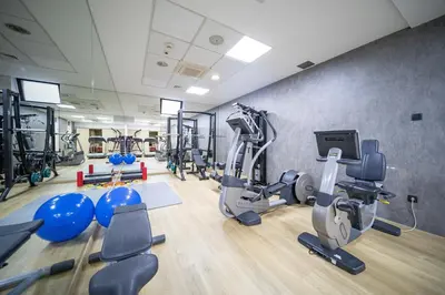a gym with treadmills ellipticals and tread machines at CRYSTAL Hotel Belgrade in Belgrade