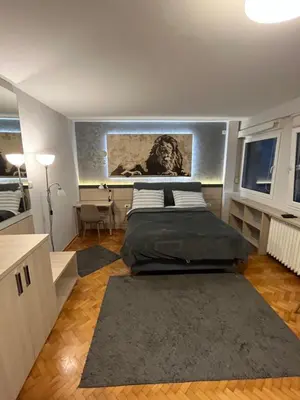 a bedroom with a bed and a painting on the wall at LEO Central Apartment in Belgrade