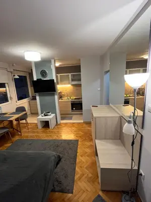 a living room with a bed and a kitchen at LEO Central Apartment in Belgrade