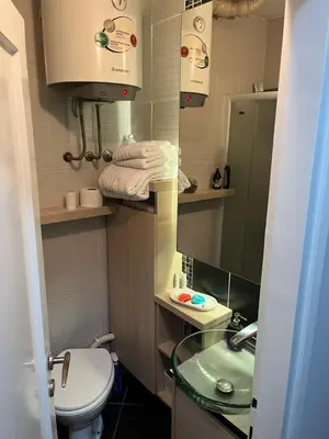 a small bathroom with a sink and a toilet at LEO Central Apartment in Belgrade