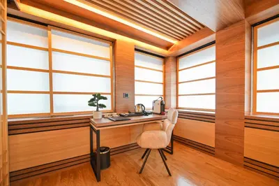 a room with windows and a desk and a chair at Hanami Design Hotel in Belgrade