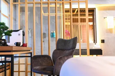 a room with a desk and two chairs and a table at Hanami Design Hotel in Belgrade