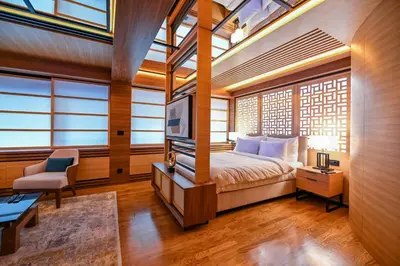 a bedroom with a bed and a tv and windows at Hanami Design Hotel in Belgrade