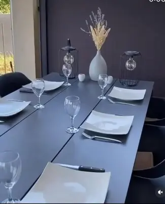 a table with plates and wine glasses on it at Vila Sunset Jugovo in Udovice