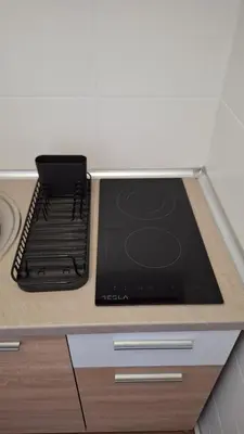a stove top oven sitting on top of a counter at Apartment Nataly in Vračar (historical)