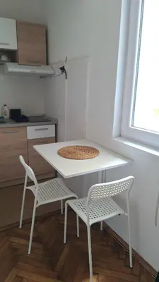 a white table and two chairs in a kitchen at Apartment Nataly in Vračar (historical)
