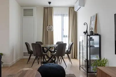 a dining room with a table and chairs at Huge 3 Bedroom Apartment With River View in Belgrade