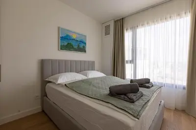 a bedroom with a large bed with a window at Huge 3 Bedroom Apartment With River View in Belgrade