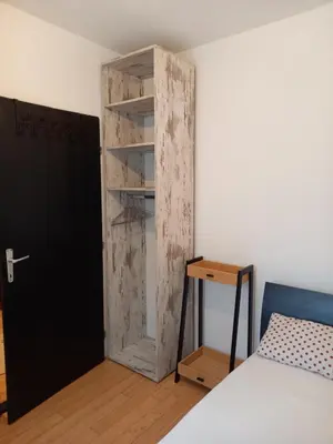a room with a door and a bed and a desk at Matisse Apartment Airport in Ledine