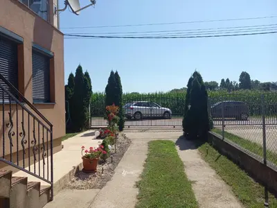 a driveway of a house with a car in the background at Matisse Apartment Airport in Ledine
