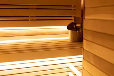 a wooden sauna with a trash can in it at Marconio Luxury city center apartment with own spa zone in Belgrade