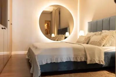 a bedroom with a large mirror and a bed at Marconio Luxury city center apartment with own spa zone in Belgrade