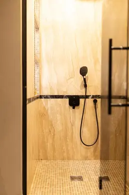 a shower with a blow dryer in a bathroom at Marconio Luxury city center apartment with own spa zone in Belgrade