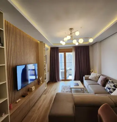a living room with a couch and a flat screen tv at APARTMAN FLORENCE in Mirijevo