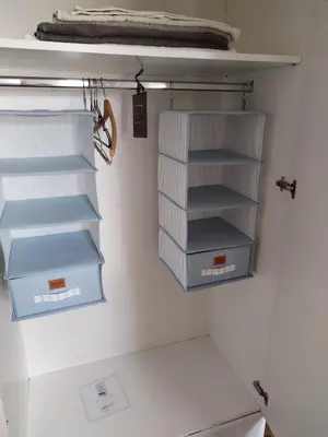 a closet with blue and white shelves and drawers at MatIne Belgrade Zvezdara in Vračar (historical)