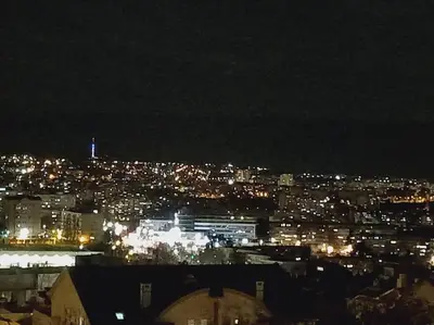 a view of a city at night with lights at MatIne Belgrade Zvezdara in Vračar (historical)