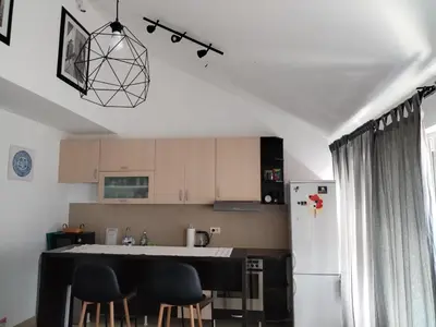 a kitchen with a black counter and a refrigerator at MatIne Belgrade Zvezdara in Vračar (historical)