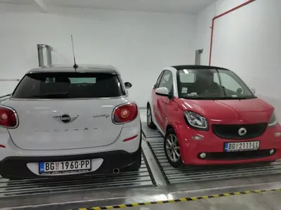 two cars parked next to each other in a parking lot at MatIne Belgrade Zvezdara in Vračar (historical)