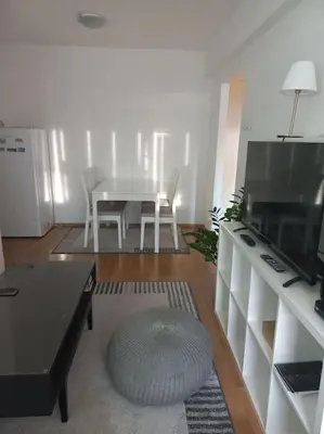 a living room with a table and a table and chairs at Cvijićeva in Belgrade