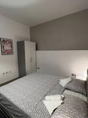 a bedroom with a bed with two towels on it at Sany Center Apartment in Belgrade